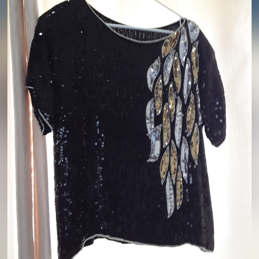 Black sequined top lined in silk.  Falling leaf design in gold and silver.
